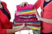 18685996-women-holding-pile-of-ironed-and-colorful-clothes.jpg